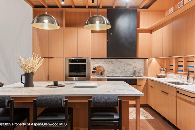 kitchen with a sink, wood finished floors, modern cabinets, a breakfast bar, and wood ceiling