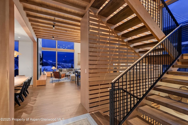 stairway featuring wood finished floors and wood ceiling