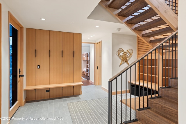 stairway featuring recessed lighting and baseboards