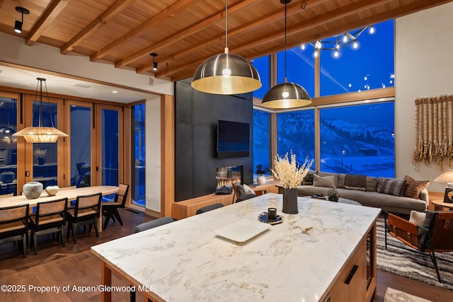 kitchen with wood ceiling, beam ceiling, open floor plan, dark wood-style flooring, and a kitchen island