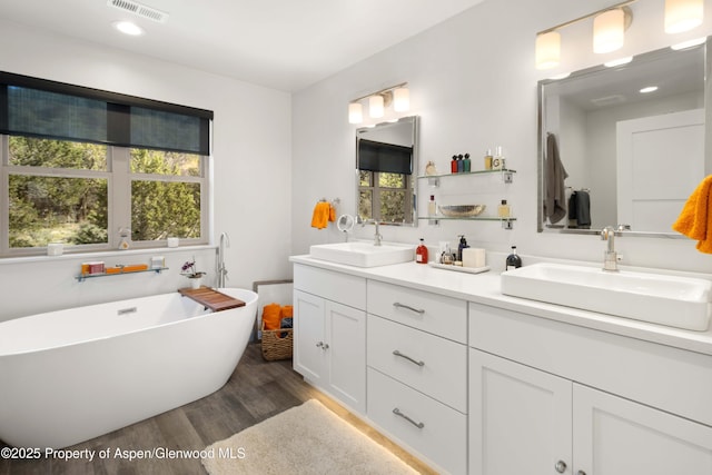 236 Paintbrush Way, Glenwood Springs, CO 81601 - bathroom with a sink, a freestanding bath, wood finished floors, and visible vents