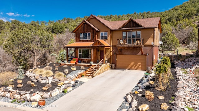 236 Paintbrush Way, Glenwood Springs, CO 81601 - chalet / cabin with covered porch, driveway, a garage, a view of trees, and stairs