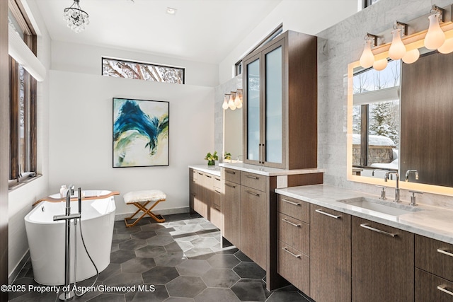 bathroom featuring vanity and a tub to relax in