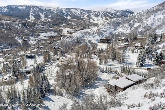 snowy aerial view with a mountain view