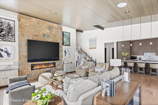 living room featuring a fireplace, hardwood / wood-style floors, and wood ceiling