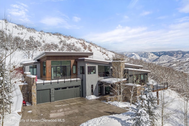 contemporary home featuring a mountain view and a garage