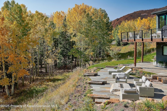 exterior space featuring a mountain view, an outdoor living space, and a patio