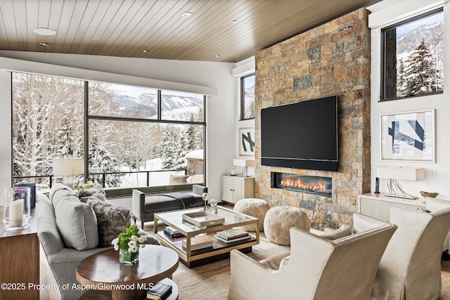 living room featuring a fireplace, lofted ceiling, wood-type flooring, and wooden ceiling