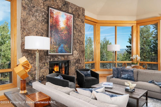 sunroom featuring a stone fireplace