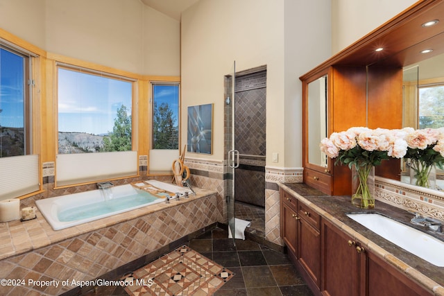 bathroom with vanity and separate shower and tub