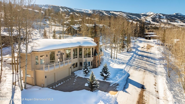 snowy aerial view with a mountain view