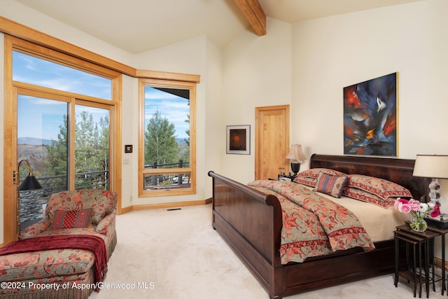 carpeted bedroom featuring access to exterior and lofted ceiling with beams