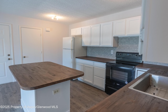 2655 Acacia Ave, Rifle, CO 81650 - kitchen with wooden counters, black electric range, dark wood finished floors, freestanding refrigerator, and backsplash