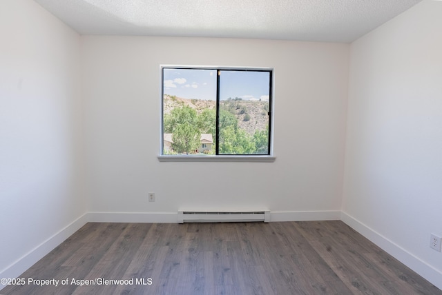 2655 Acacia Ave, Rifle, CO 81650 - empty room with a baseboard radiator and wood finished floors