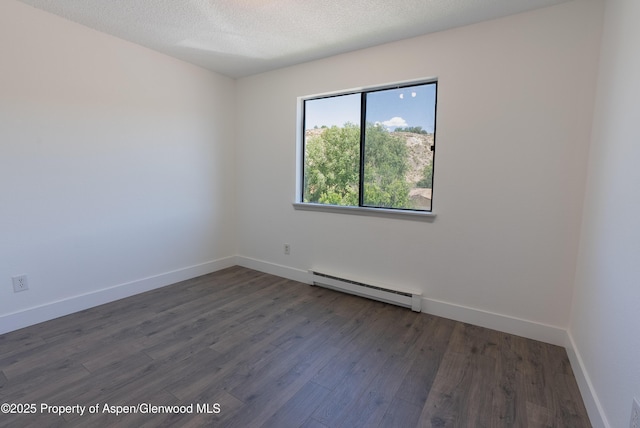2655 Acacia Ave, Rifle, CO 81650 - unfurnished room with baseboard heating, wood finished floors, and a textured ceiling