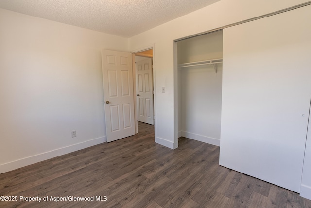 2655 Acacia Ave, Rifle, CO 81650 - unfurnished bedroom featuring wood finished floors, a closet, and a textured ceiling