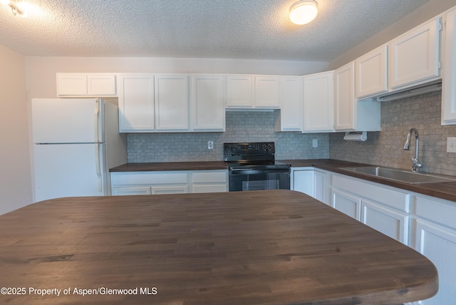 2655 Acacia Ave, Rifle, CO 81650 - kitchen with black electric range oven, freestanding refrigerator, backsplash, wood counters, and a textured ceiling