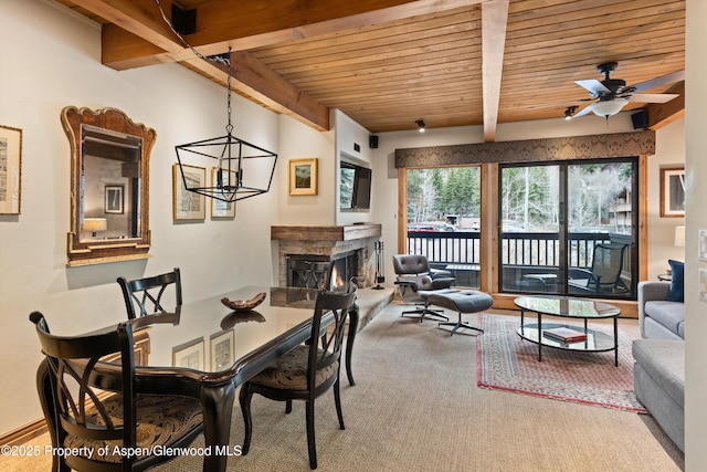 610 S W End St Unit D203, Aspen, CO 81611 - dining space featuring a high end fireplace, wooden ceiling with exposed beams, a ceiling fan, and carpet flooring