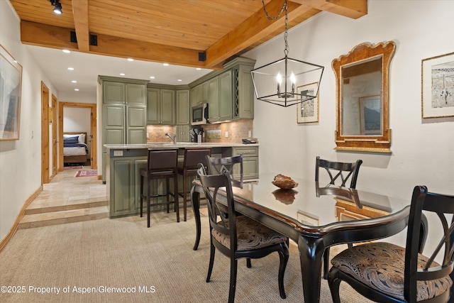 610 S W End St Unit D203, Aspen, CO 81611 - dining space with wood ceiling with exposed beams, a chandelier, recessed lighting, light colored carpet, and baseboards