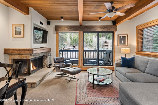 610 S W End St Unit D203, Aspen, CO 81611 - carpeted living area featuring wood ceiling with exposed beams, a fireplace, and a ceiling fan