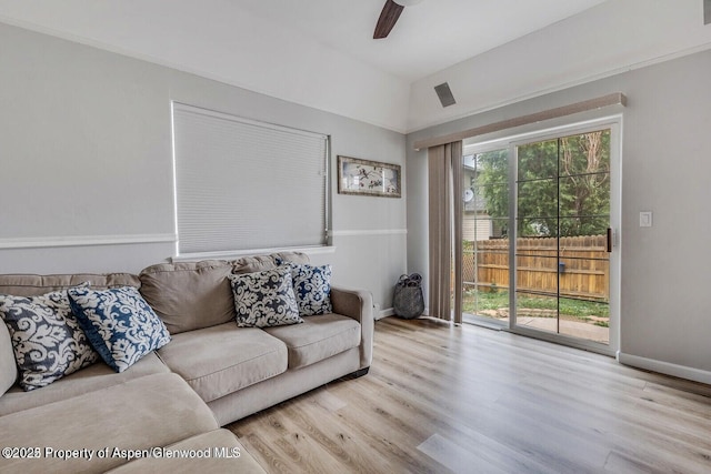 living room featuring a ceiling fan, plenty of natural light, wood finished floors, and baseboards