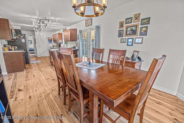 1321 Lecuyer Dr, Craig, CO 81625 - dining room with a chandelier, light wood-style floors, and baseboards