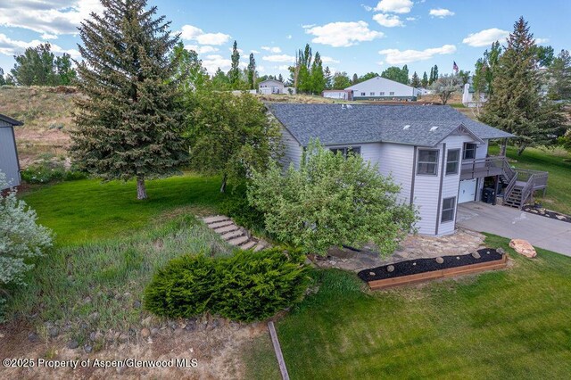 1321 Lecuyer Dr, Craig, CO 81625 - back of property featuring a garage, a yard, and concrete driveway