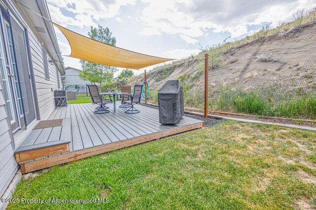 1321 Lecuyer Dr, Craig, CO 81625 - wooden deck with outdoor dining area, a grill, and a lawn