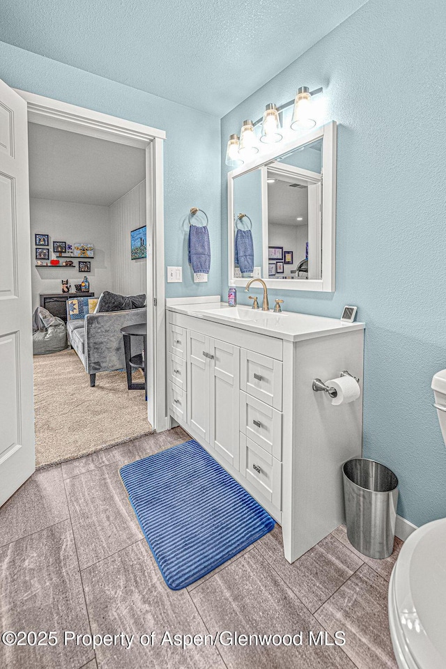 1321 Lecuyer Dr, Craig, CO 81625 - bathroom with vanity, toilet, and a textured ceiling