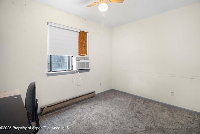 carpeted spare room with a baseboard radiator and ceiling fan