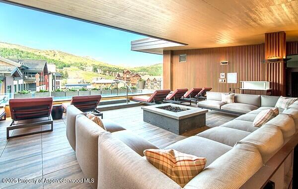 45 Wood Rd Unit 301, Snowmass Village, CO 81615 - living room with a mountain view, wood finished floors, and wood ceiling