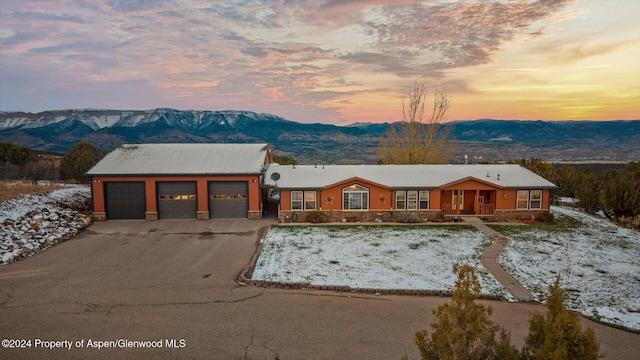 view of front of property featuring a garage and a mountain view