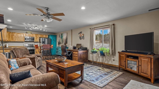 living room with ceiling fan and dark hardwood / wood-style floors