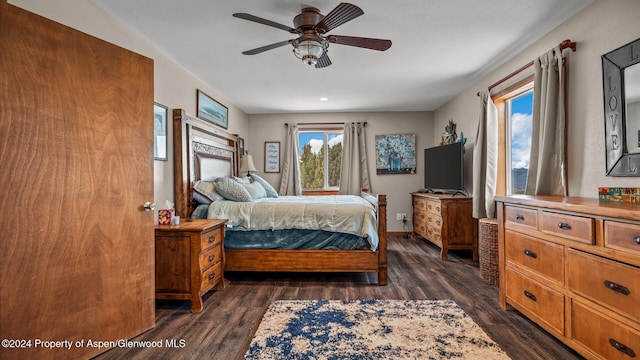 bedroom with ceiling fan and dark hardwood / wood-style floors