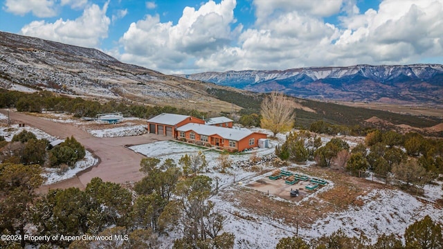 snowy aerial view featuring a mountain view