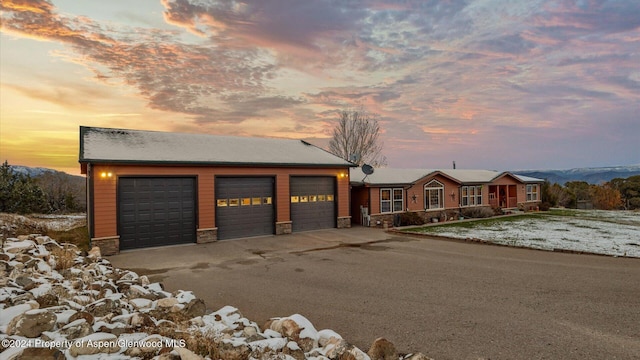 view of front of property with a garage and a mountain view