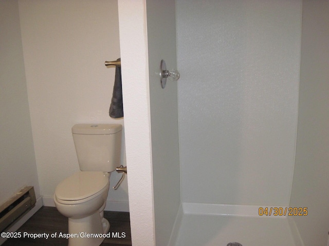 bathroom with toilet, baseboards, and baseboard heating