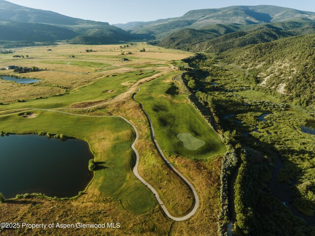 drone / aerial view with a water and mountain view