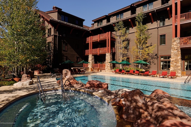 0075 Prospector Rd Unit 8405Summer Interest, Aspen, CO 81611 - community pool featuring a community hot tub and a patio area