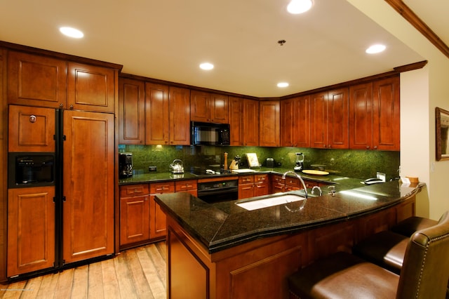 0075 Prospector Rd Unit 8405Summer Interest, Aspen, CO 81611 - kitchen featuring black appliances, light wood-style floors, dark stone counters, decorative backsplash, and a peninsula