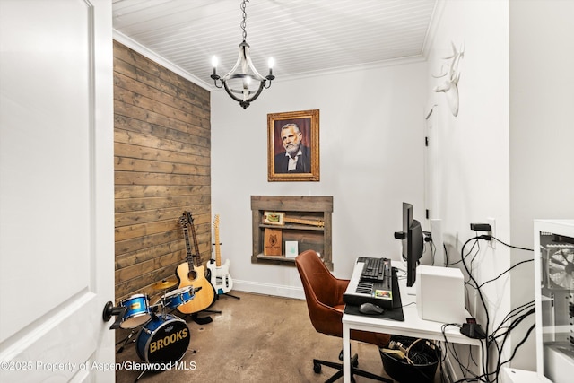 office space featuring an inviting chandelier, concrete floors, and ornamental molding