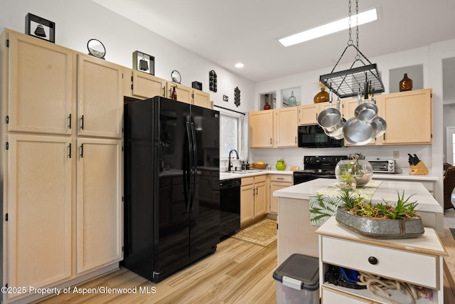 100 Limberpine Cir, Parachute, CO 81635 - kitchen featuring black appliances, light brown cabinetry, light countertops, light wood-style flooring, and recessed lighting