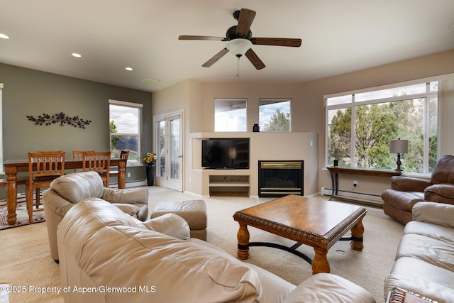 50 N Ridge Ct, Battlement Mesa, CO 81635 - living area with a baseboard heating unit, recessed lighting, light carpet, a ceiling fan, and a glass covered fireplace
