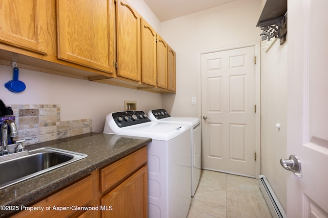 50 N Ridge Ct, Battlement Mesa, CO 81635 - laundry room featuring washing machine and dryer, cabinet space, a baseboard heating unit, and light tile patterned floors