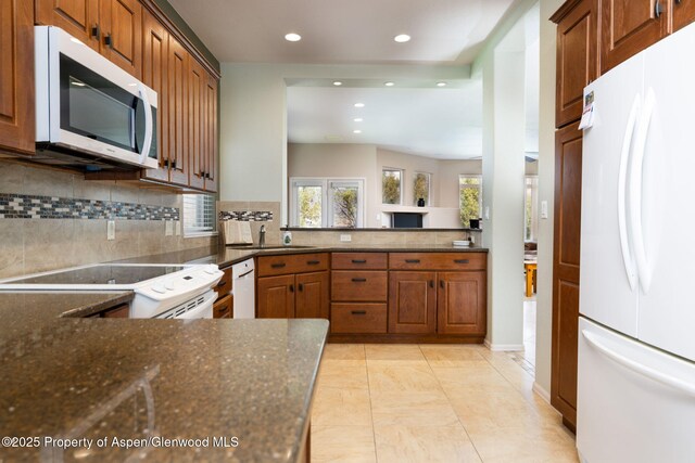 50 N Ridge Ct, Battlement Mesa, CO 81635 - kitchen featuring white appliances, recessed lighting, decorative backsplash, a sink, and dark stone countertops