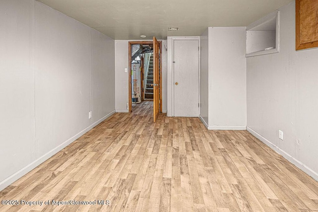 415 Tucker St, Craig, CO 81625 - unfurnished bedroom featuring light wood-style flooring, baseboards, and water heater