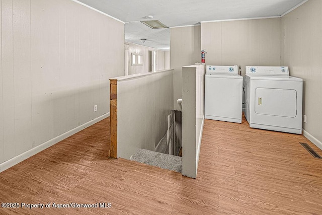 415 Tucker St, Craig, CO 81625 - laundry room featuring washer and dryer, wood finished floors, baseboards, and ornamental molding