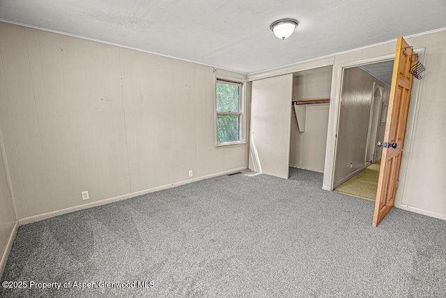 415 Tucker St, Craig, CO 81625 - unfurnished bedroom featuring carpet, a closet, baseboards, and ornamental molding