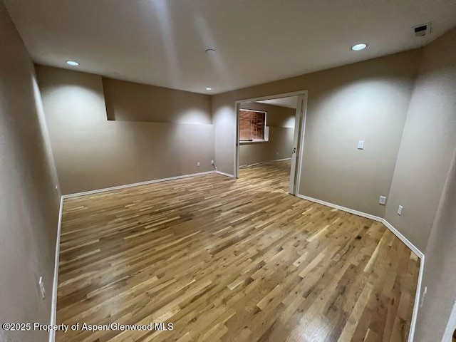 unfurnished room with hardwood / wood-style flooring