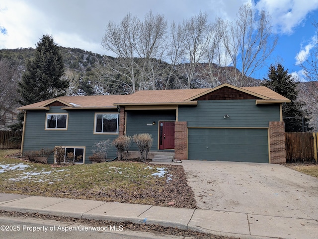 single story home with a mountain view and a garage